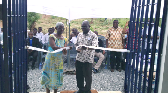 Ms Dora Dankwah Darko (left), Assistant Headmistress of PRESEC, being assisted by Prof. Felix Ankomah Asante (right), President of the 1983 Year Group to cut the tape to inaugurate  the facility