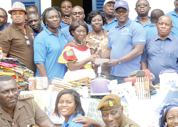 Mr Ferdinand Nimako (right) presenting some items to ASP Victoria Adu-Amoah  Foli (left) at the Borstal Institute in Accra