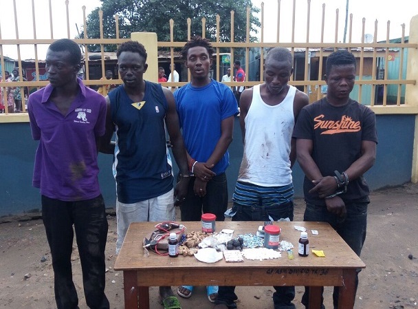 The gang members paraded behind their drugs