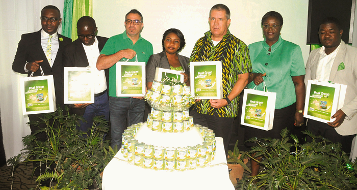  Mr Marc Desenfans (3rd right), Business Development Director of FrieslandCampina West Africa, Wilfried Assi (extreme left), the Marketing Manager of the company  and other officials jointly launching the new peak green product in Accra. Picture: GABRIEL AHIABOR