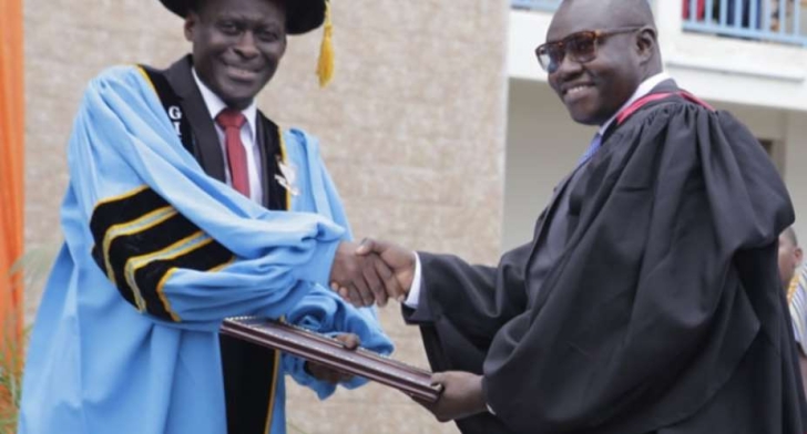 Mr Enoch Darfah Frimpong (right) receiving an award as the most promising graduate in media management from Mr Ebo Afful. acting Vice-Rector of GIJ