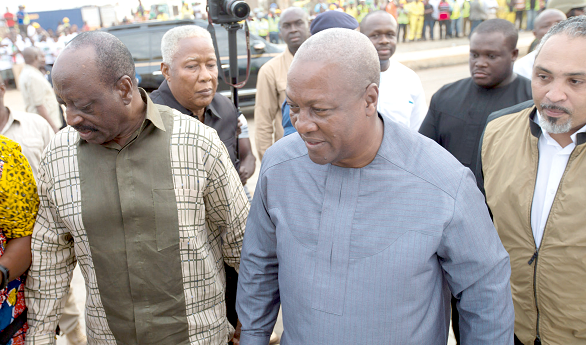 Dr Kwaku Agyemang Mensah (left),  the Minister of Water Resource, Works and Housing, conducting President Mahama round the Saglemi housing project