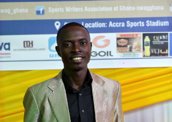 Abrefa displaying his SWAG award with a grin
