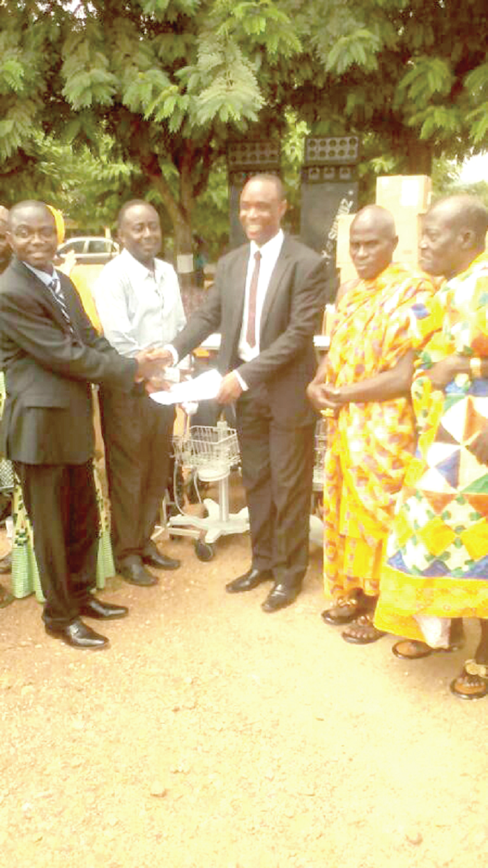 Mr Reuben Bedzrah (3rd right) receiving a list of the items from Dr Nicholas Fosu at Mankranso