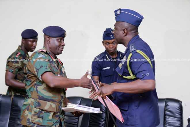 Lieutenant General Obed Akwa (left), the Chief of the Defence Staff, exchanging pleasantries with Mr David Asante-Apeatu after the press conference. Picture: EMMANUEL ASAMOAH ADDAI