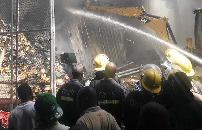 Firemen dousing the fire with water