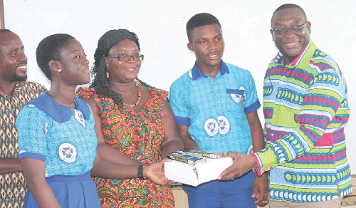 Nana Adwoa Owiredu (left), the Girls’ Head Prefect, and Master Edwin Tawiah (2nd right) of Victory Presby Church School receiving the items on behalf of the school from Mr Yaw Boaben Asamoa. Also in the picture is Dr Mrs Angelina T. Mensah, the Municipal Director of Education. Picture: MAXWELL OCLOO
