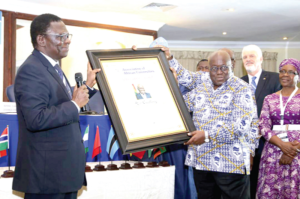 Prof. Olusola Oyewole (left), the President AAU, presenting an appreciation certificate to President Akufo-Addo. Picture: Samuel Tei Adano