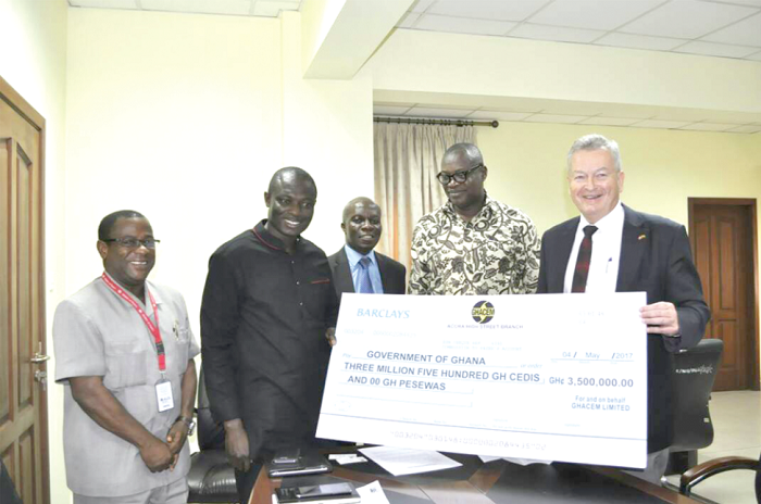 Mr Morten Gade (right) supported by Dr George Dawson-Ahmoah (2nd right) handing over a dummy cheque to Mr Kwaku Kwarteng (2nd left), while Mr Tony Dadzra and Mr David Quist of the Ministry look on
