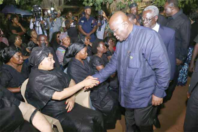 President Akufo-Addo consoling Madam Victoria Banford (left), mother of the deceased, at the residence of Major Maxwell Adam Mahama. Also in the picture is Mrs Barbara Adam Mahama seated 2 and left)