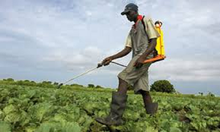 A farmer spraying his farm with agro-chemicals