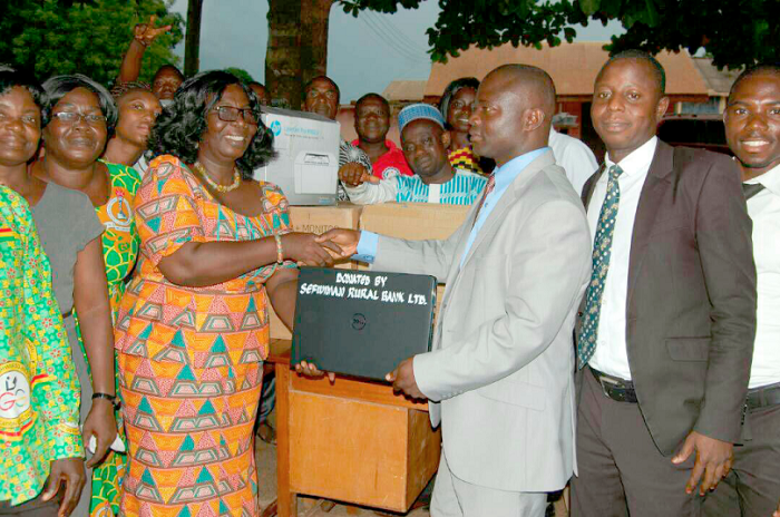 Mr Richard Kwaku Adjei (right) presenting the items to Mrs Mercy Emefa Boateng