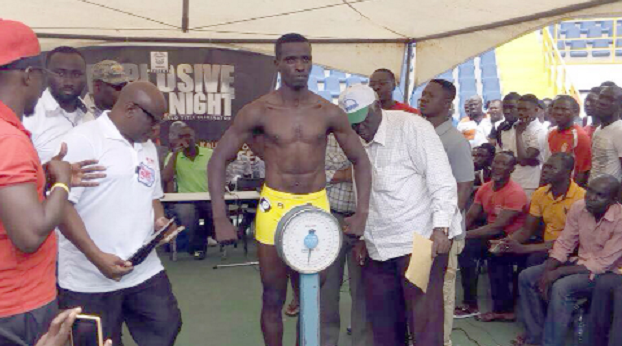 Obodai Sai being weighed by IBF African President, Onesmo Ngoul (left)