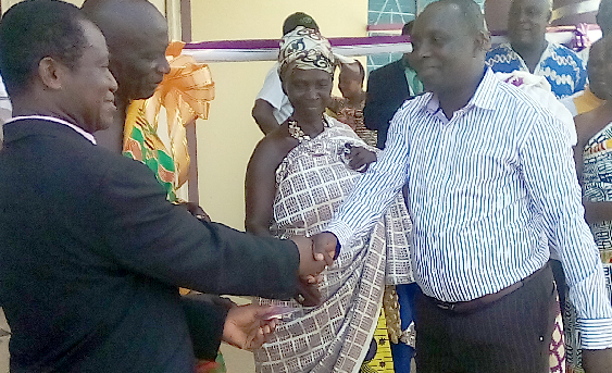 Mr Francis Owusu (left), the contractor of God’s Favour &amp; Mercy Limited, handing over keys to the bungalow (inset) to the Board Chairman of the Dominase SDA Hospital, Pastor Stephen Anokye