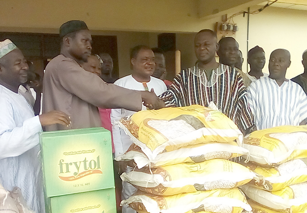 Nana Okyere Tawiah Antwi (right), the DCE for Atwima Kwanwoma, in a handshake with Dr Suleiman Ahmed after presenting the food items to him