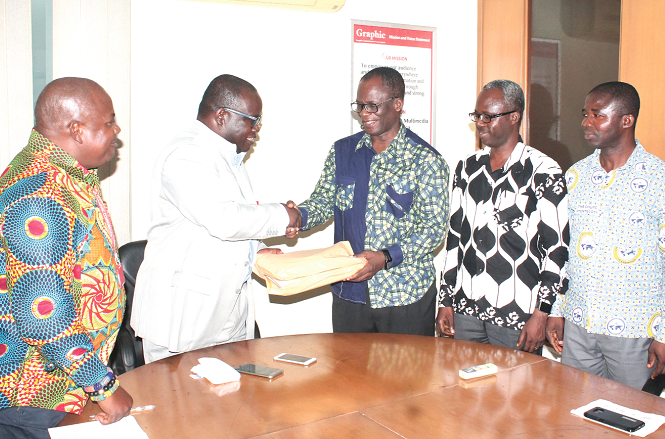 Apostle Samuel Yaw Antwi (3rd right) presenting the signed petitions to Mr Ken Ashigbey (2nd left), Convenor for Media Coalition Against Galamsey (MCAG). Looking on are Mr Ernest Asigiri (2nd right), Administrator of GCPP, Mr Ransford Tetteh (left), Secretary of MCAG, and Mr Fred Tettey Amoako (right), Assistant Editor at the Church of Pentecost Headquarters. Picture: Maxwell Ocloo