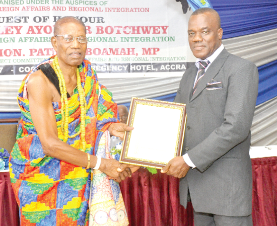 Mr Paul Ansah (right), the Logistics Manager of Plot Enterprise Ghana Ltd, receiving a Gold Award in manufacturing  from Nii Kpobi Tettey-Tsuru III, the La Mantse