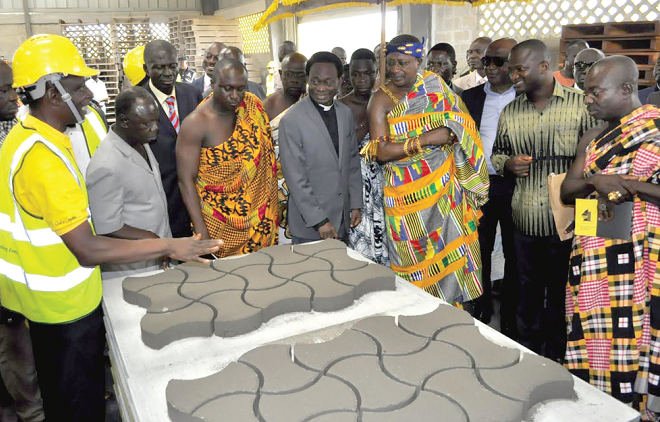 Mr Eric Duku (left) briefing dignitaries on operations of the company