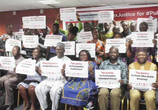 Dignitaries together with participants displaying posters to commemorate World Public Services Day in Accra. Picture: EDNA ADU-SERWAA 