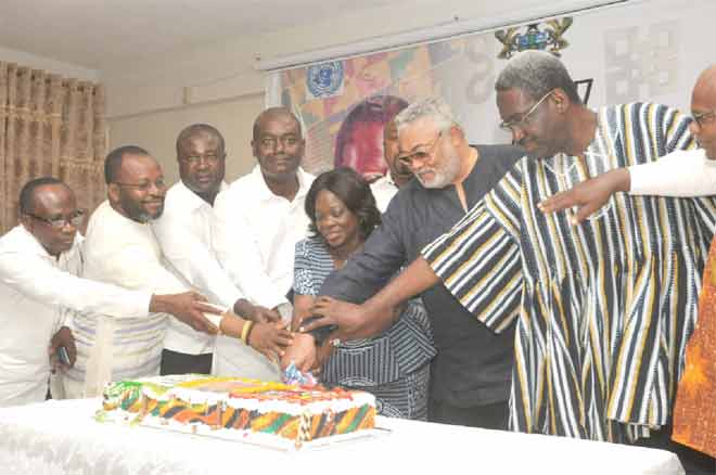 Former President,  Ft Lt Jerry John Rawlings, being assisted to cut the 70th birthday cake donated by CLOGSAG. Among them is Nana Agyekum Dwamena (right), the Head of Civil Service. Picture: EBOW HANSON
