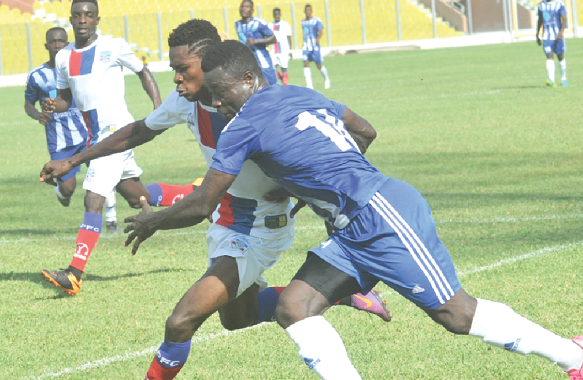 Paul Fiatsi (right) in a tussle with a Liberty player for the ball