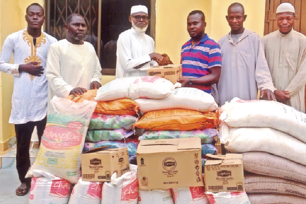 Hajj Batalima (third from the left) presenting some of the items to the La Paz Muslim Community Chairman, Mallam Abdallah Sayeed, while other members of the community and SAFOAD look on 
