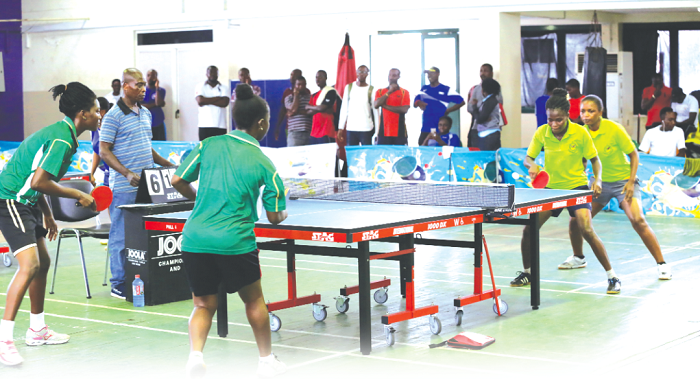 • In this women’s doubles game Immigration ladies (right) take on their counterparts from the Army (left in green)