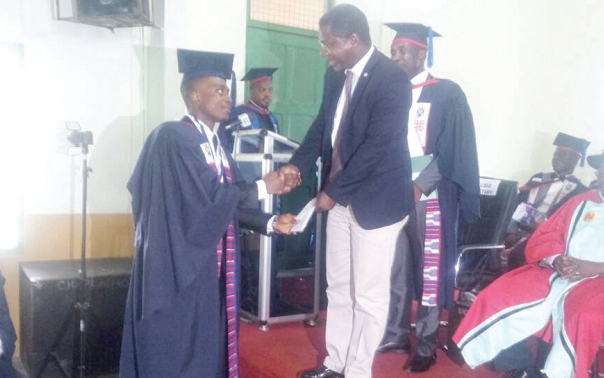 Dr Samuel Awuku, a consultant of Transforming Teacher Education and Learning (T-TEL), presenting an award to David Sarpong, the Overall Best Student