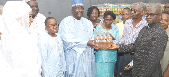 Dr Mahamudu Bawumia (4th left) presenting an item to Ms Mahella  Narh (3rd right), the Headmistress of Akropong School for the Blind