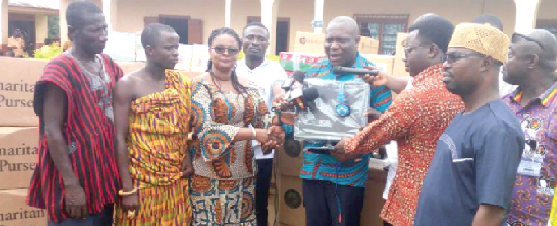 Mr Vincent Odotei Sowah presenting the computers to the District Director of Education 