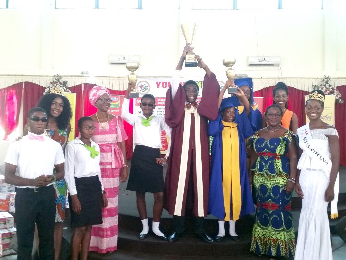 Winners of the competition in a group photograph with some of the invited guests displaying their trophies.