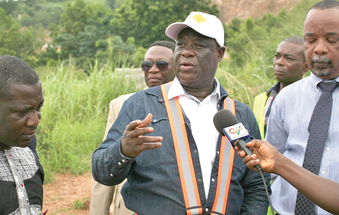 Mr Amoako-Attah (middle) briefing the media after a visit to Weija Hills and the Kasoa Toll Booth