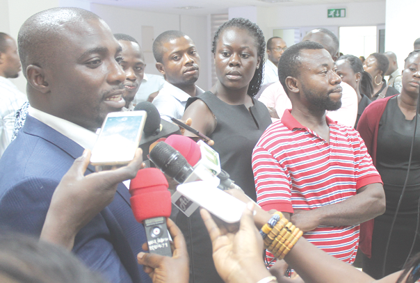 Mr Isaac Boateng (left), Manager, Regulatory Administration Division, NCA, explaining a point to some journalists after the workshop in Accra