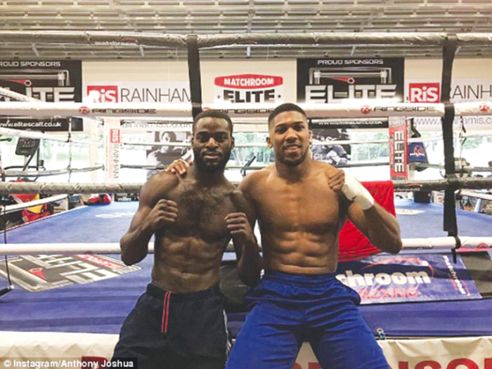 Joshua Buasti (left) being prepared by his mentor, Anthony Joshus,  for his first bout