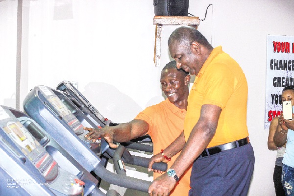 Rev. Steve Mensah exercising on one of the fitness machines