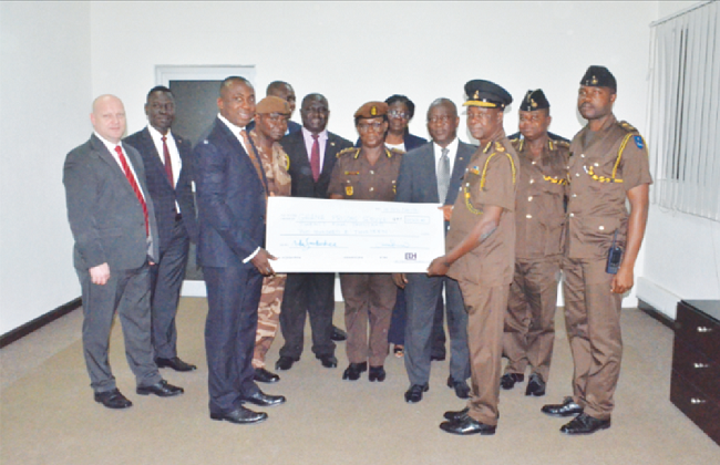Mr Emmanuel Adu-Sarkodee (3rd left) presenting a dummy cheque to Mr Emmanuel Yao Adzator