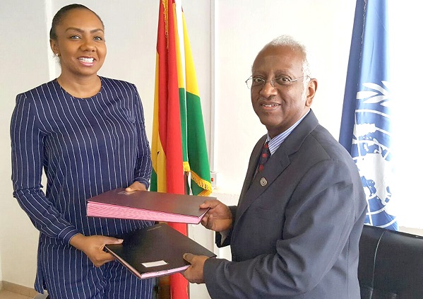 Ms Patty (left) and Mr Haile exchanging the MoU after the signing