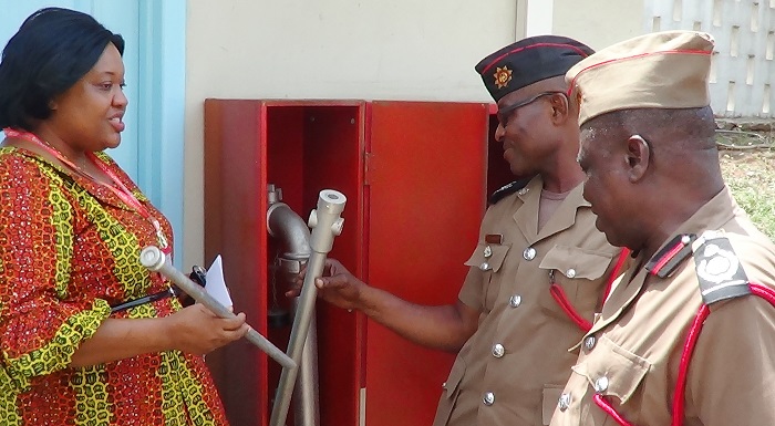 Mrs Peace Gadogbe explaining some points to DCFO William Yawson, leader of the Fire Service team which came for the inspection. Picture: INNOCENT K. OWUSU