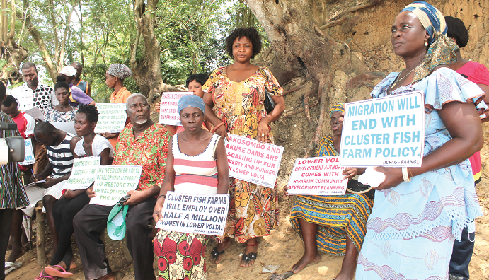 Some residents of Aveyime, a fishing community in the Volta Region, with placards calling for government support  Picture: EDNA ADU-SERWAA