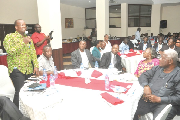 Alhaji Yahaya Yakubu (left), Director of Housing at the Ministry of Works and Housing, making a remark at the meeting.