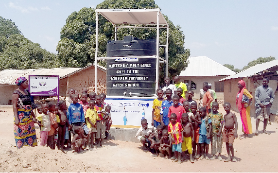 Some children at Gyamutu community standing by the inaugurated solar-powered water kiosks
