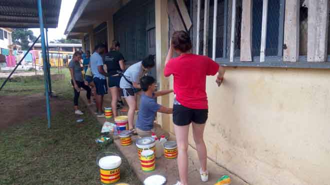 Some of the students painting a building at the School for the Deaf at Akropong