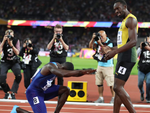 Despite clinching gold Justin Gatlin bows at the feet of Usain Bolt