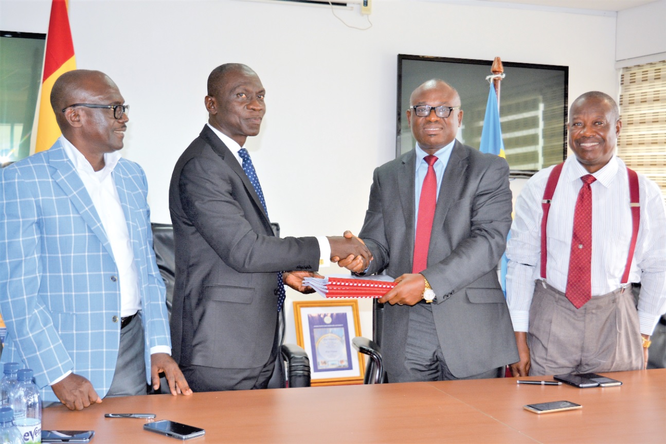 Mr Paul Asare Ansah (2nd right), the Director General of GPHA, exchanging the agreement with Mr Kwame Gyan after signing. Looking on are Mr Edward Mettle-Nunoo (right), the General Manager of Legal Services at GPHA and Nana Yaw Boahene (left), Director at Ibistek