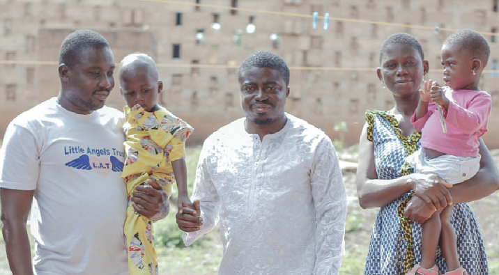 Mr Issah Abdulai(left) Country Manager of Uton,  with the baby and his father