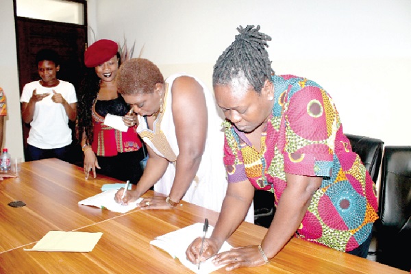 Dr Prospera Dzang-Tedam and Mrs Elsie Gaisie-Ahiabu, Co-authors of the book, autographing copies for guests. Picture: Maxwell Ocloo