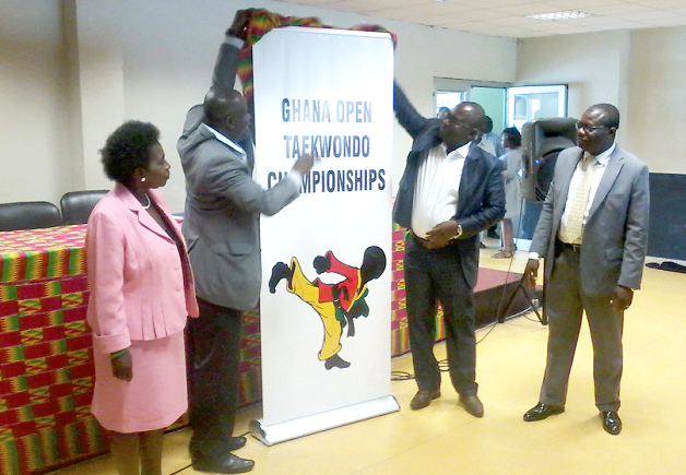 The Director General of the NSA, Mr Robert Sarfo Mensah (right), with the support of the Director of Sports at the NSA, Mr Joshua Mensah, unveiling the logo for the tournament while the president of the GTF, Mr Frederick Lartey Otu, looks on