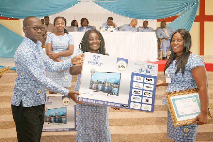 Ms Gifty Ohene (right), receiving a long service award from Mrs Emma Owusu Amoah, Board Member. On the left is Mr Kwaku Owusu, the Head of Human Resource of the Bank