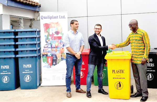 Mr Joseph Akl (2nd left), supported by the General Manager, Mr Shady Salloum (left), handing over the bins to Mr Desmond Appiah