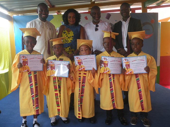 Mr Phillip Ayensu (left), Mrs Irene Ayensu (2nd left), Mr Yoofi Grant (2nd right), and Mr Benjamin Peprah Bookie-Danka (right), in a pose with some of the graduates